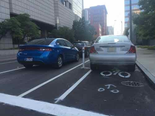 The 2nd block, East of 9th, starts off protected -- but I found a Ford Focus parked in the bike lane. It had two tickets.  