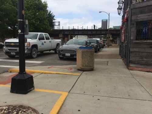 Looking North we see how the "curb bulb" encloses the end of the parking lane on the East side of Broadway, Why wasn't the curb on the West side bulbed out as well? 