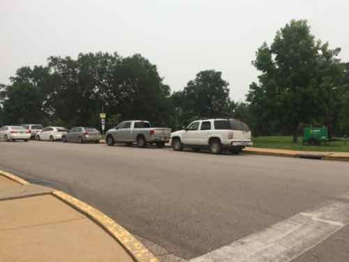 The last three vehicles are parked in the bus stop I need to get home