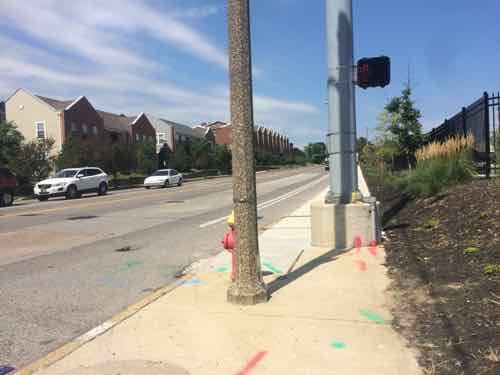 I'm at the ramp to cross Chouteau going South, the pedestrian button is on the back side of the silver pole! The visible button the side of the pole to cross Tucker heading East. 