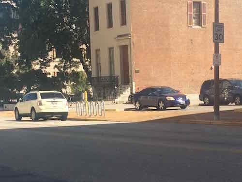 At 3:19pm I'm across the street trying not to look conspicuous -- as well as a shaved head guy in a wheelchair can.