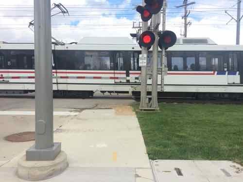 The sidewalk narrows at the track crossing, this is the low point in the experience. 