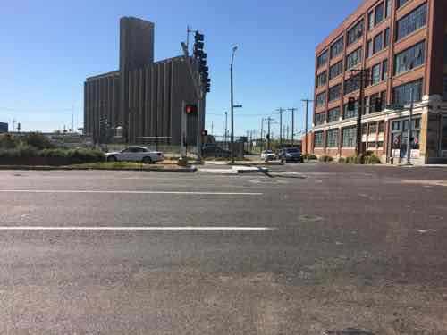 Looking South across Forest Park. IKEA is to the left, just out of view. The development parcel straight ahead will ideally be of similar massing as the lofts on the right, with storefronts at sidewalk level. 