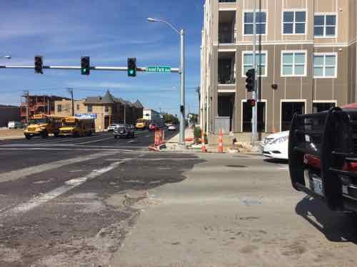 From the pedestrian refuge in the median I see the curb ramp on the other side aren't finished. At this point I notice the pedestrian signals speaking for the visually impaired say "Forest Park Parkway" instead of "forest Park Avenue" The visual signs on the street lights are correct though