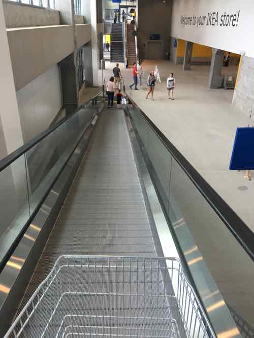 At the exit you can use the elevator, stairs, or travelator to get to the ground for. The travelator holds carts so they don't roll down. Be prepared to push the cart at the bottom. 