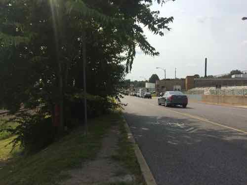 Looking West I was concerned the bus driver wouldn't be able to see me. A path was worn in the grass from others using this stop. 