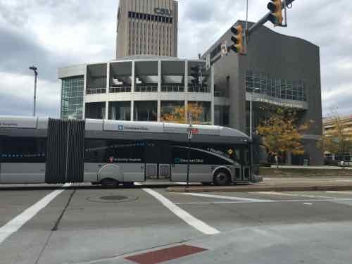 The Heathline is traveling Eastbound in its bus-only lane. The Cleveland State University Student Center in the background was built after the BRT line opened.