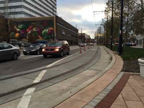 Looking West on Central Parkway from Walnut, the streetcar track cut into the median to make the turn into the near land on Walnut. At numerous intersections cameras are able to detect the streetcar, causing the traffic signals to go into a special mode to stop all traffic -- in this case allowing the streetcar to turn right across several lanes of traffic. 