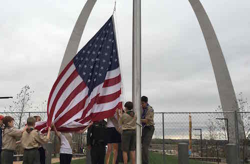 Boy & Girl Scouts raise the American Flag on the new pole at Luther Ely Smith Square on October 28, 2015, 