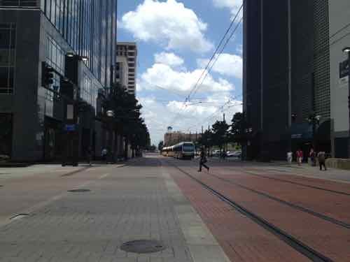 Dallas has a few spots where cars & transit use the same street. Transit here travels considerably slower than where it has an exclusive right-of-way.