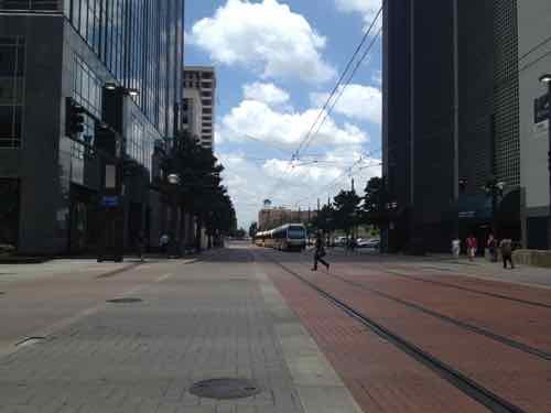 Dallas has a few spots where cars & transit use the same street. Transit here travels considerably slower than where it has an exclusive right-of-way. 