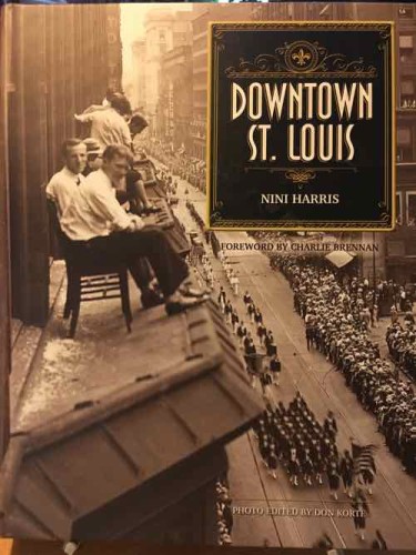 The cover shows men on the roof of an Arcade building bay window watching a parade on Olive