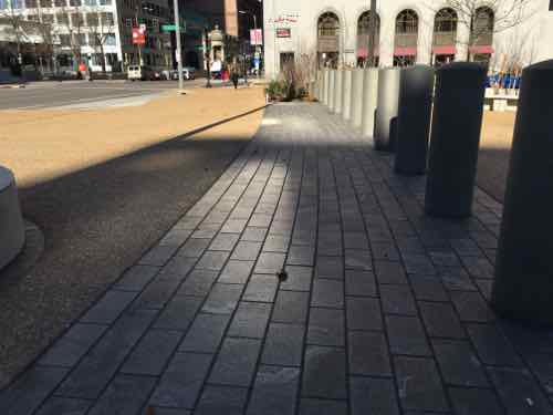 Mostly the new walkways are a smooth exposed aggregate concrete, but brick was used in some locations. 