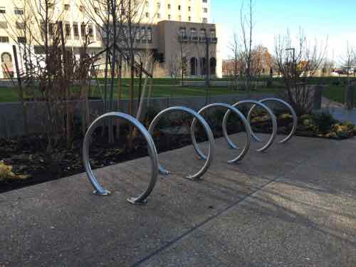 Modern bike racks, that will support the bike frame, are along the South &amp; North outer walkways.
