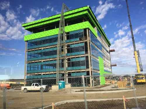 Just to the North we see construction of a new building next to one bus stop. 