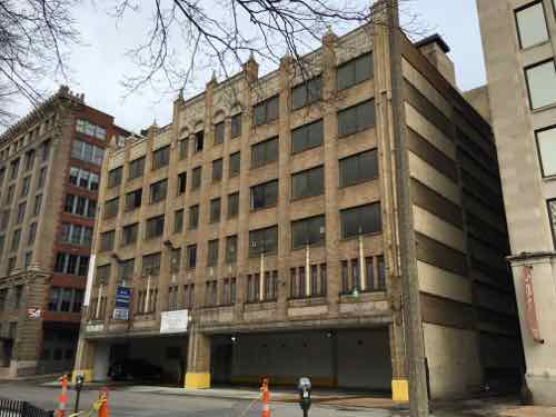 The garage faces 13th Street, across the street is Lucas Park. Barely visible is the Shell Building (right)