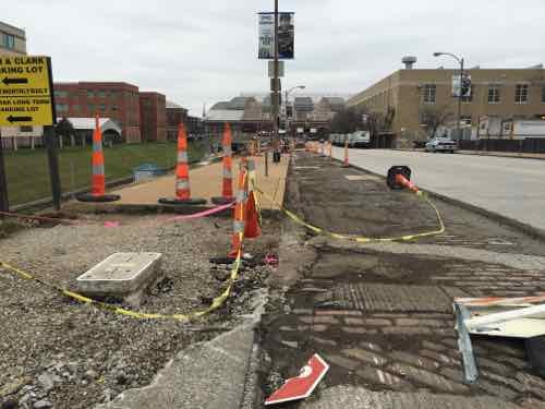 The asphalt in the parking lane was removed, sidewalk & curb ramp at 16th also removed, December 2015
