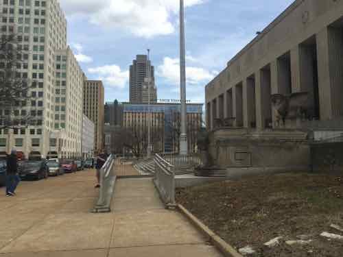 The raised platform helped elevated the building above the then-bust city sidewalks. The ramp wasn't installed until this century. 