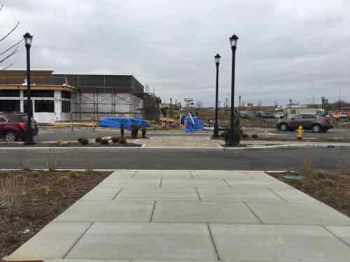 Looking West at restaurants under construction. In the foreground is another non-ADA crossing 