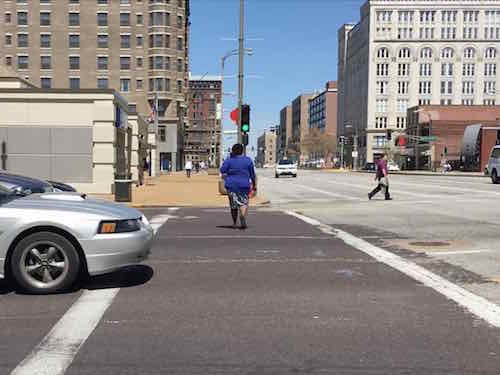 NB on the West side of Tucker we see a woman crossing with the green. What you can't see ifs the left-turn lane has an an arrow to turn right in her path! 