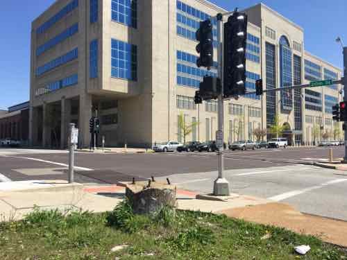 When I went back I confirmed no button is needed to cross 20th but you do need to press a button top cross Olive. The signs are wrong, the button next to each crosswalk is what is wired. 