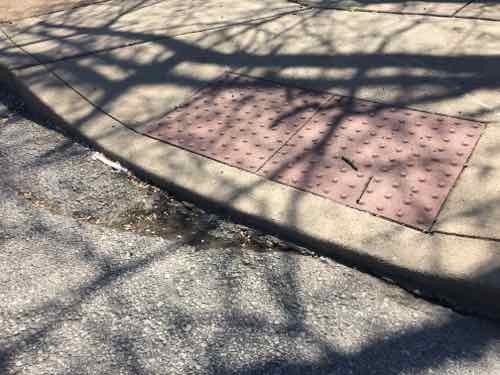 The same ramp again. Like hundreds/thousands of curb ramps it was built too high relative to the paving. Plus, like so many, the paving right in from is partially missing. I have to role in Ewing a little bit to get to a driveway. 