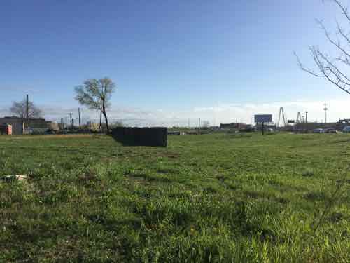 View from 13th looking at the proposed grocery store site. The wall is the last bit of the tunnel where the commuter train went under Tucker