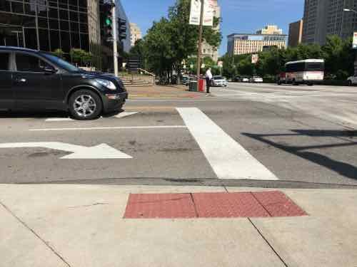 The vehicle stop line is in direct conflict with the unmarked crosswalk