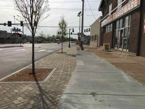 Looking East toward Lucas &amp; Hunt, wider sidewalk with trees. What's hard to see in person and it pictures the right rises up higher than the left side