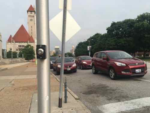 This view shows cars waiting next to a line of cars parked on the street
