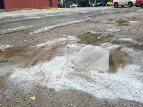 Standing water in some of the many holes in the paving, August 23rd