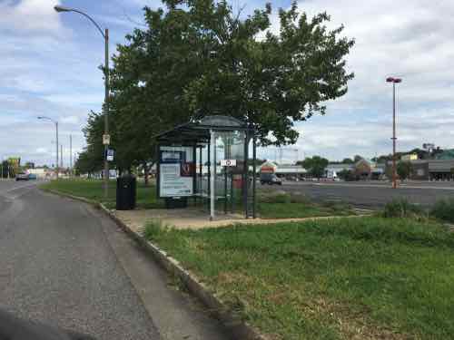 The next stop also has a space for the bus and a shelter, but no sidewalk along Manchester