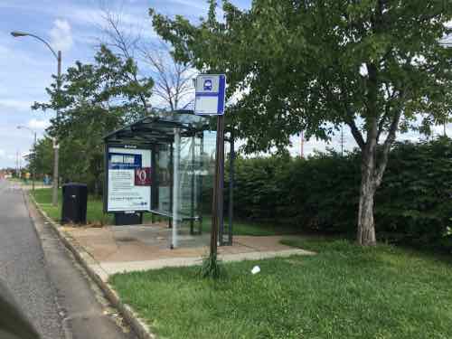 The last of the four stops in front of the shopping center also has a shelter. Here you can see concrete was recently added -- the old walkway next to the shelter was too narrow to meet the ADA minimum. 