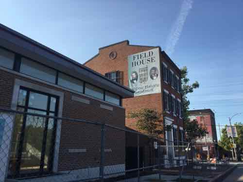 Excellent details include selective concrete/stone work, quality brick, black windows. The two are connected via a glass walkway set back from the street. This allows old &amp; new to stand on their own merits.