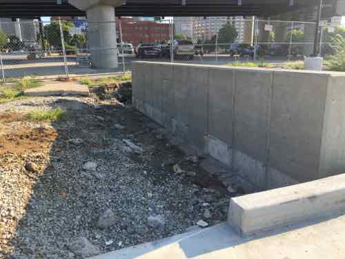 One of my favorite things is the visual extension of the foundation line on the North side of the parking lot driveway. It's a small element, but it helps greatly in the separation of parked cars from pedestrian. 