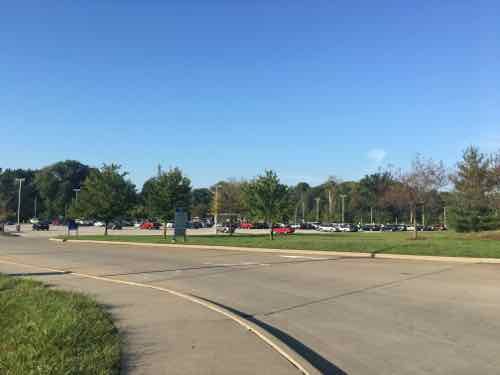 Out looking back we see the main parking lot -- another is to the left out of frame. Most likely the new building will be built on the grassy area to the right. 