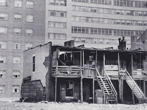 ABOVE: Image from the film with tenement in front and a housing project behind