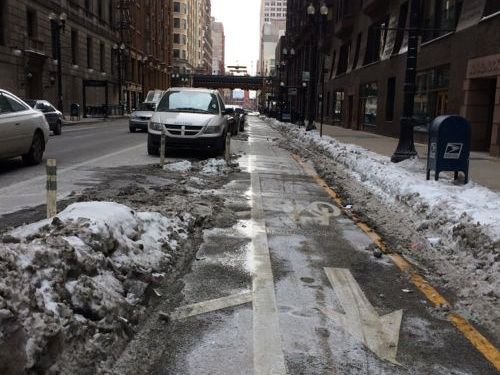 A protected bike lane on S. Dearborn was cleared of snow.