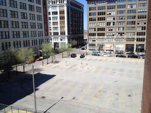 By May 2014 the frequently full parking lot was empty, but begging to be rented by the hour & month. Click image for post. 