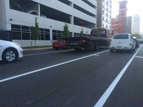 In this block auto parking is on both sides of a single traffic lane, which the city truck had blocked. 