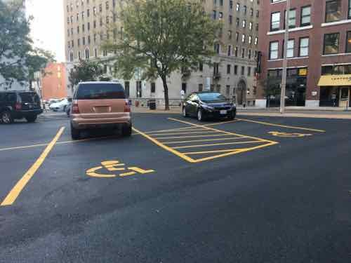 On October 10th I replied to various building dept officials because required vertical signs still weren't in place at the three disabled spots. 