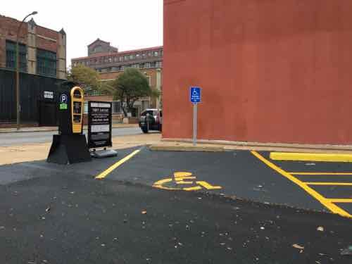 A vertical sign at one disabled spot had also ben installed, as required by code and the ADA